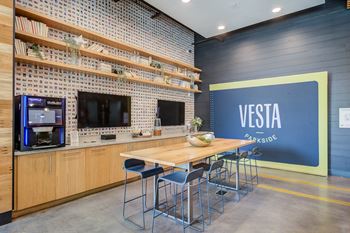 a dining area with a wooden table and chairs and a blue wall with a visa logo on